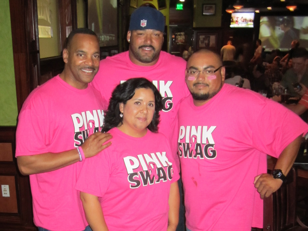 Four Pink Swag supporters wearing matching pink shirts