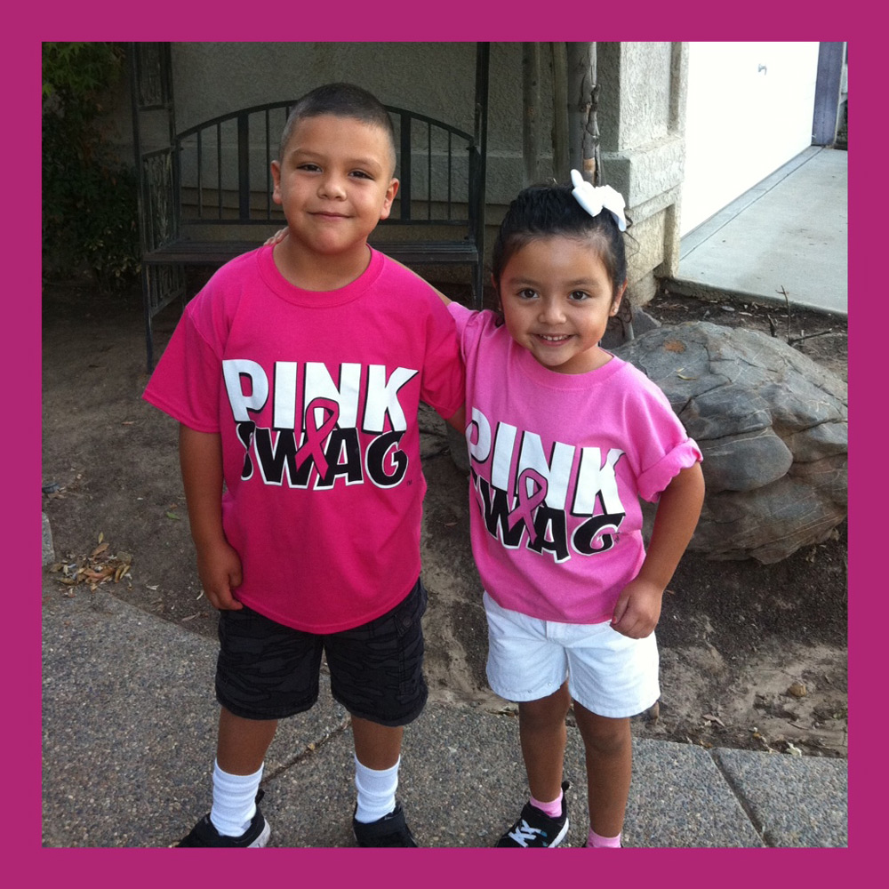 Two children wearing matching Pink Swag shirts